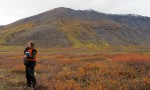 Researcher talks on satellite phone in backcountry